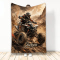 ATV throw blanket featuring a helmeted off-road rider racing through a rugged mountain landscape