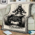 Close lifestyle view of an ATV blanket with an off-road rider, quad artwork, and tire-track border