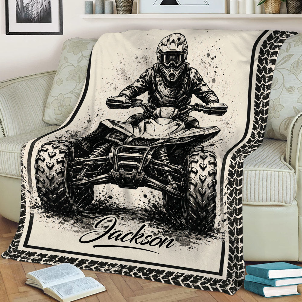 Close lifestyle view of an ATV blanket with an off-road rider, quad artwork, and tire-track border