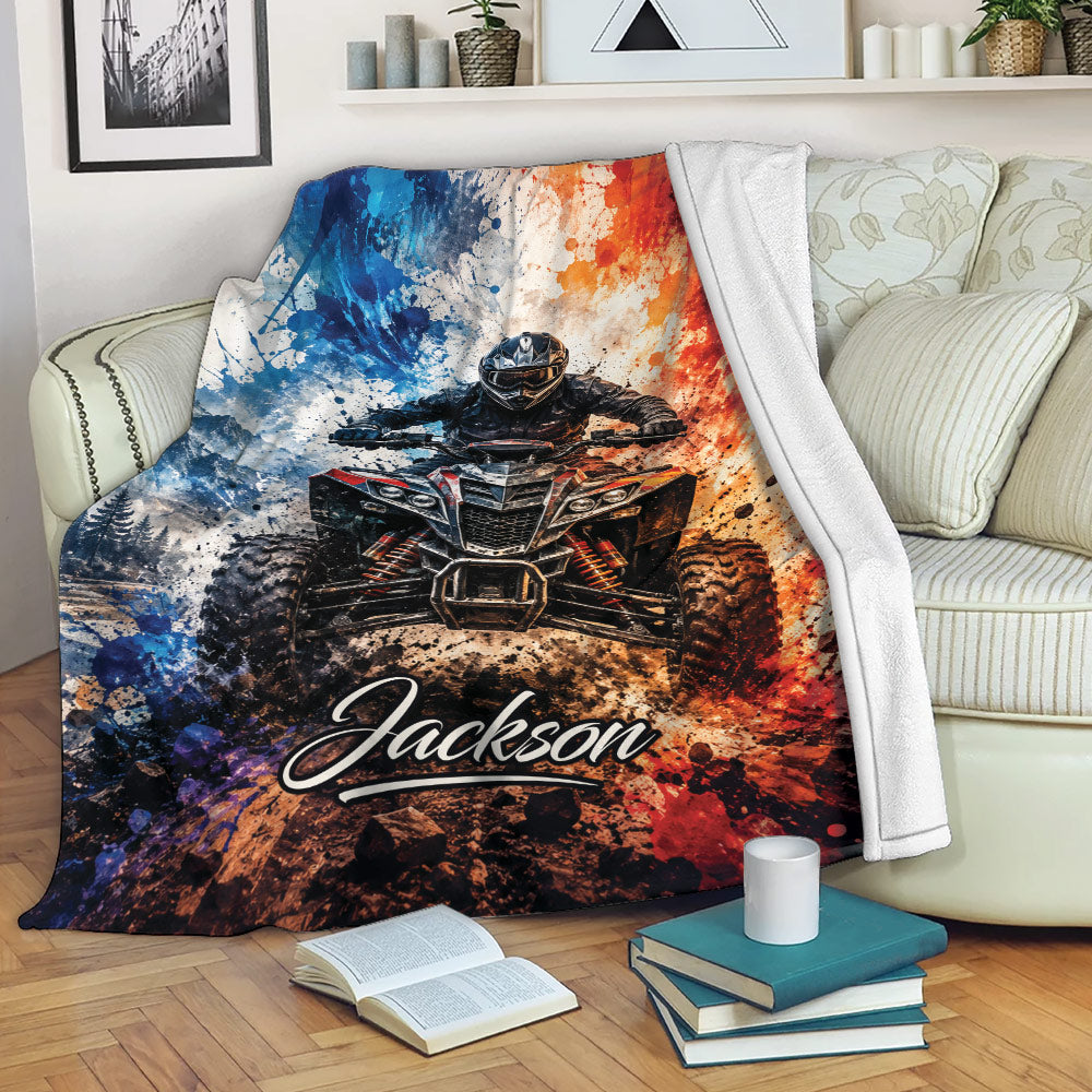 ATV blanket draped over a sofa with an off-road quad rider, rugged mountain scene, and colorful action artwork