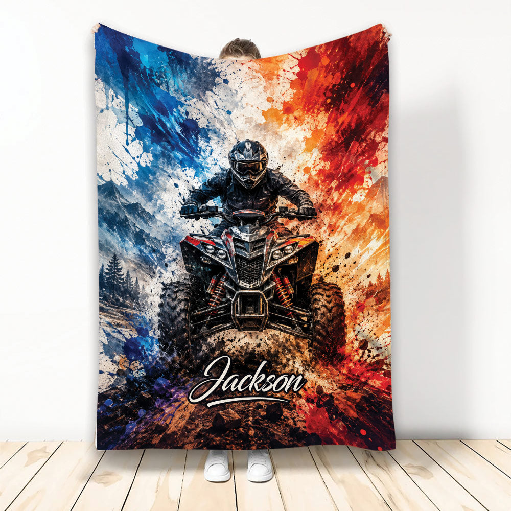 ATV throw blanket featuring an off-road quad rider, mountain scenery, mud splashes, and bold blue and red artwork