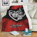 Red ATV throw blanket draped over a sofa with bold all-terrain vehicle rider artwork