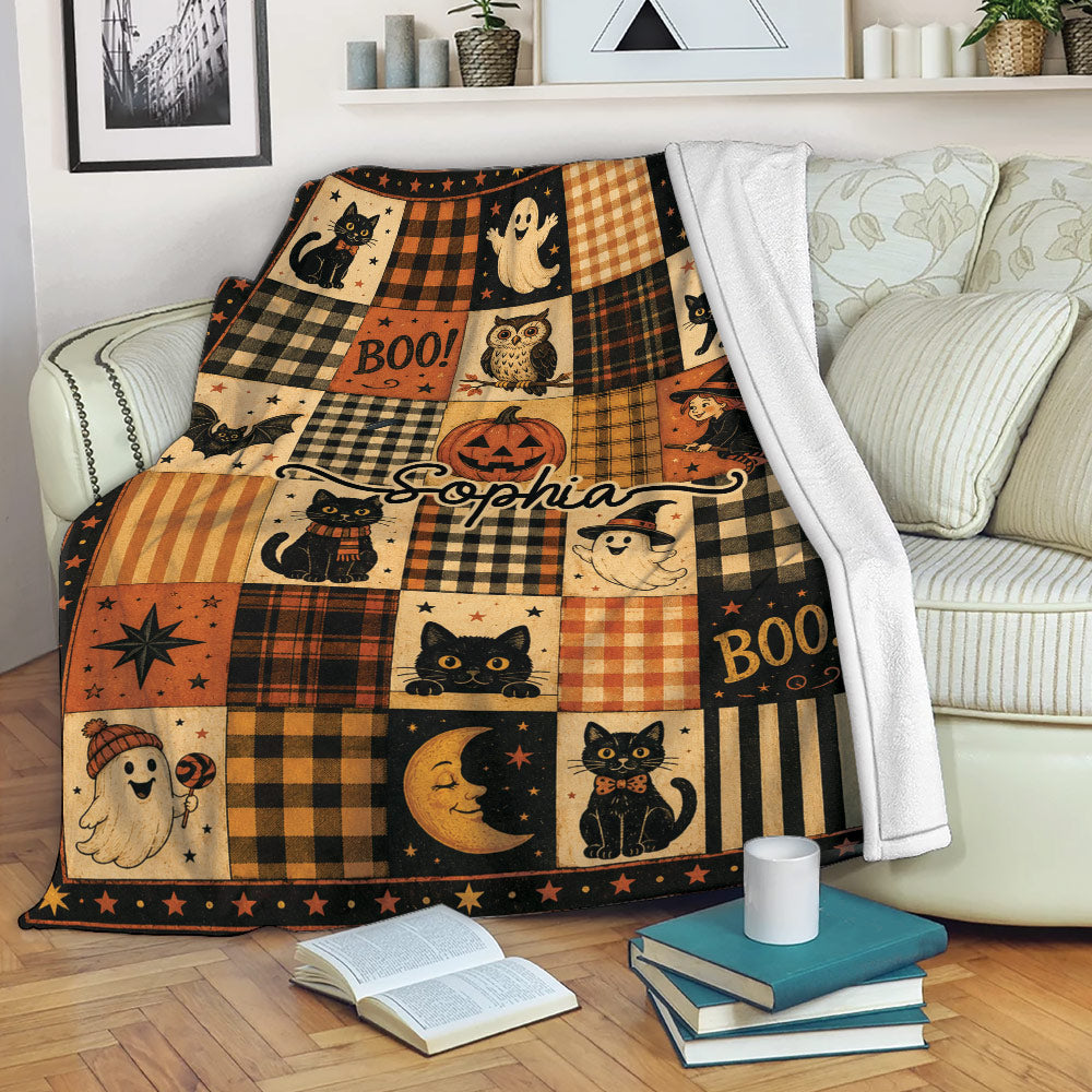 Spooky Halloween throw blanket draped over a sofa with cats, ghosts, pumpkins, and autumn plaid squares