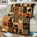 Halloween couch blanket featuring black cats, bats, ghosts, pumpkin, witch, owl, and retro patchwork design