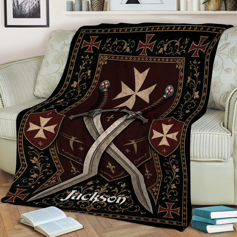 Close lifestyle view of a Knights Templar blanket featuring crossed swords, shields, and ornate red and black artwork
