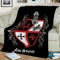Knights Templar blanket draped over a couch, featuring an armored helmet, heraldic shield, and crosses