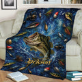 Fishing blanket displayed on a couch with illustrated fish, rods, reels, lures, and splash-filled blue artwork