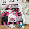 Cheerleading throw blanket displayed on a sofa with pink, black, and white cheer-themed artwork