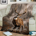 Wildlife deer blanket displayed on a couch with a buck, forest background, and fall-inspired tones