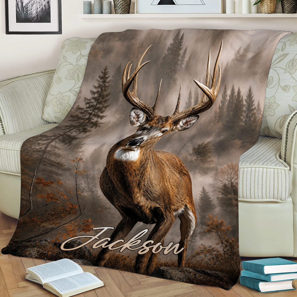 Wildlife deer blanket displayed on a couch with a buck, forest background, and fall-inspired tones