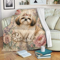 Shih Tzu throw blanket draped over a sofa in a cozy living room with floral dog artwork
