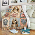 Shih Tzu blanket draped over a sofa with floral dog artwork and cozy living room styling