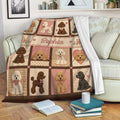 Poodle blanket draped over a sofa, showing colorful dog artwork, floral details, and cozy living room styling