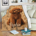 Poodle blanket displayed on a sofa with a curly brown dog design and playful pet motifs