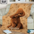 Poodle throw blanket draped over a couch with a curly brown dog and paw print artwork