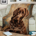 Labrador Retriever artwork blanket draped across a sofa with books nearby