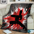 Karate throw blanket draped over a couch with striking martial artist and abstract splatter artwork