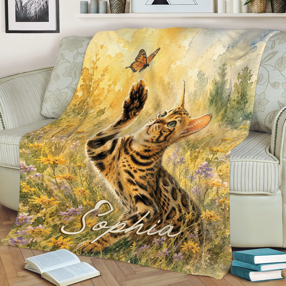 Watercolor Bengal cat blanket displayed on a sofa with wildflower artwork