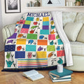 Sign language alphabet throw blanket displayed on a sofa with bright hand-sign artwork