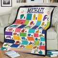 Colorful sign language alphabet blanket draped over a couch with illustrated hand gestures