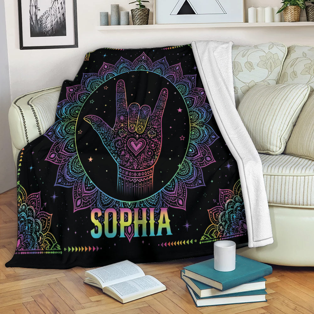 Sign language throw blanket displayed on a sofa with colorful mandala artwork and starry details