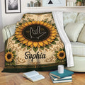 Sign language blanket draped over a sofa with sunflower artwork and a warm decorative border