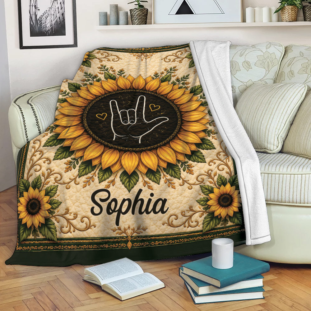 Sign language blanket draped over a sofa with sunflower artwork and a warm decorative border