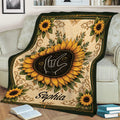 Sunflower sign language throw blanket displayed across a chair with ornate botanical details