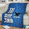Blue swimmer throw blanket displayed on a sofa with pool water texture and sports artwork