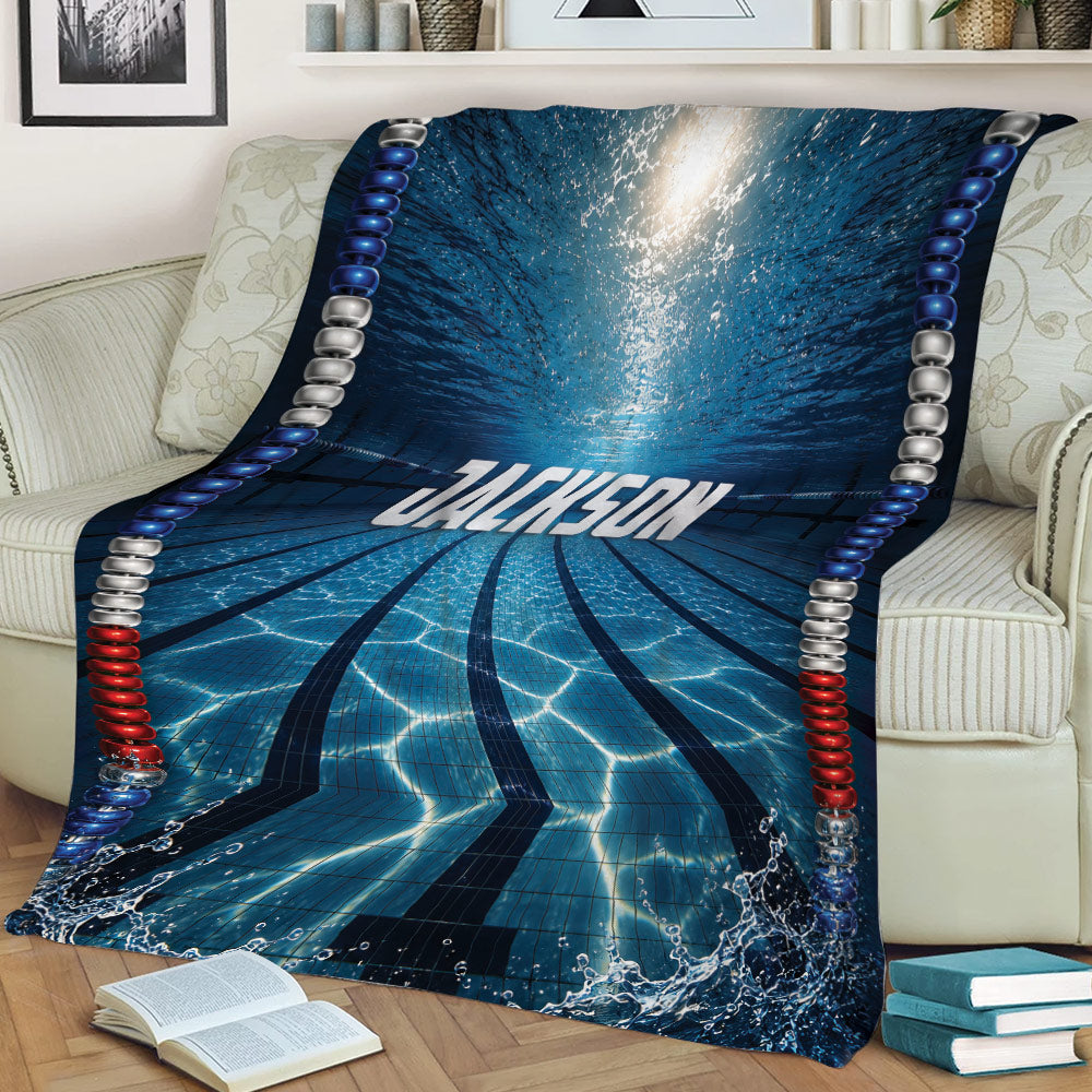 Blue swimming pool lane blanket styled across a sofa with underwater reflections and racing lane lines