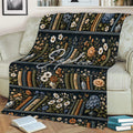 Floral bookshelf blanket displayed on a sofa with open books and reading nook decor