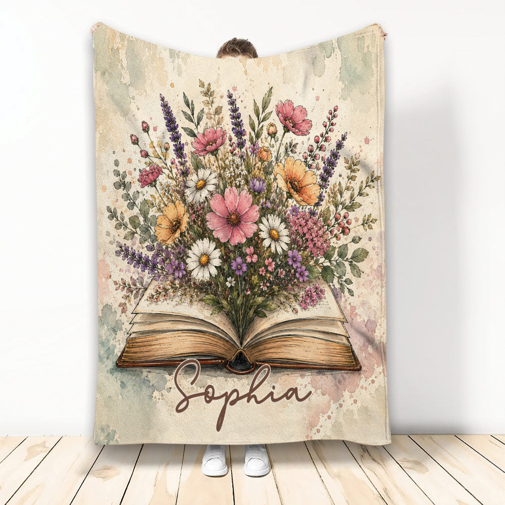 Open book blanket with a colorful floral bouquet and soft watercolor-style botanical artwork