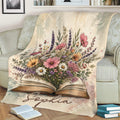Floral open book blanket displayed on a sofa with books arranged nearby