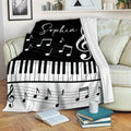 Piano throw blanket draped over a sofa with keyboard keys and musical note artwork