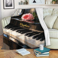 Piano blanket draped over a sofa, showing grand piano keys, floral artwork, and a cozy living room