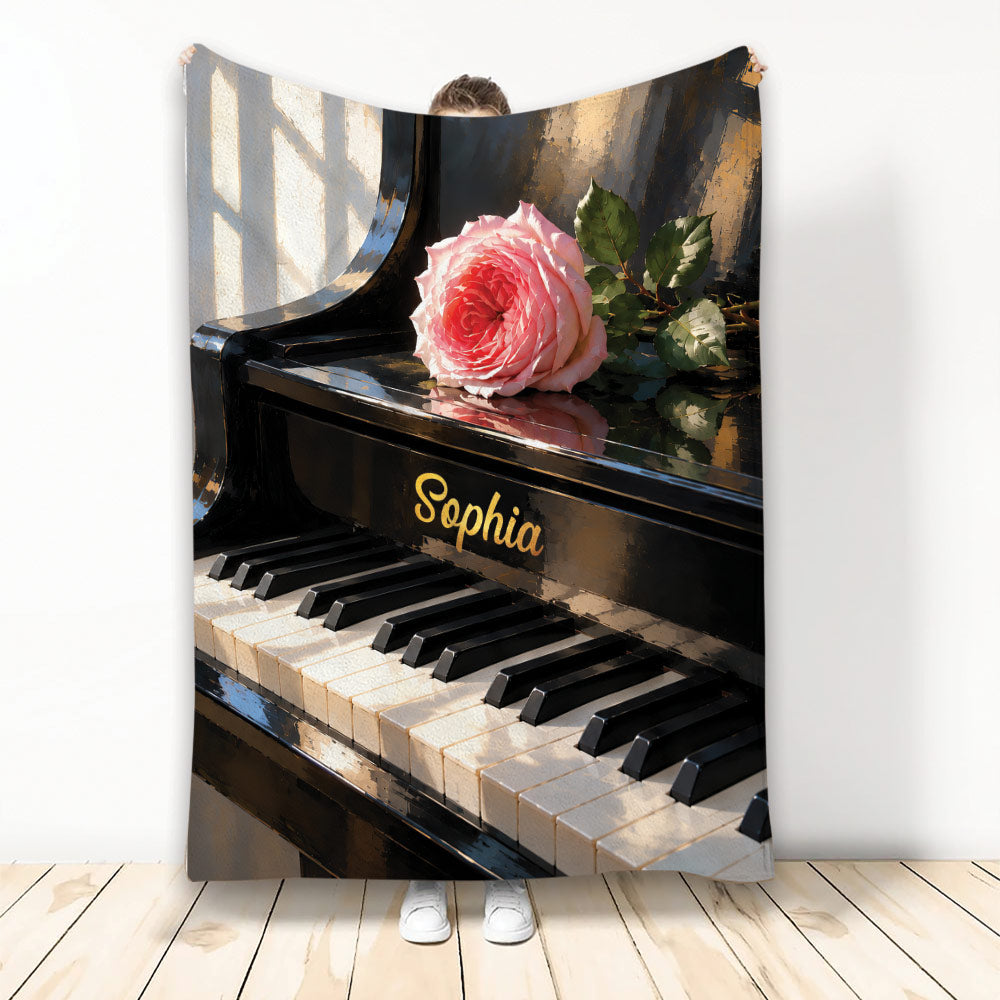 Piano throw blanket featuring a glossy grand piano, piano keys, and a pink rose design