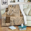 Great Pyrenees blanket draped over a sofa with gentle dog artwork, paw prints, and rustic family-themed details