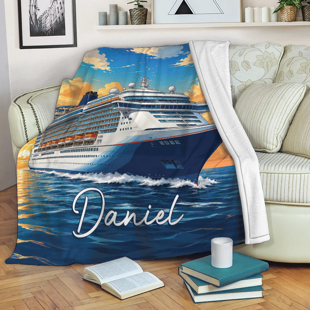 Cruise ship blanket draped over a sofa, showing a ship at sea beneath a colorful sunset sky