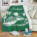 Green cruise ship blanket draped over a sofa with tropical island artwork and a cozy reading setting
