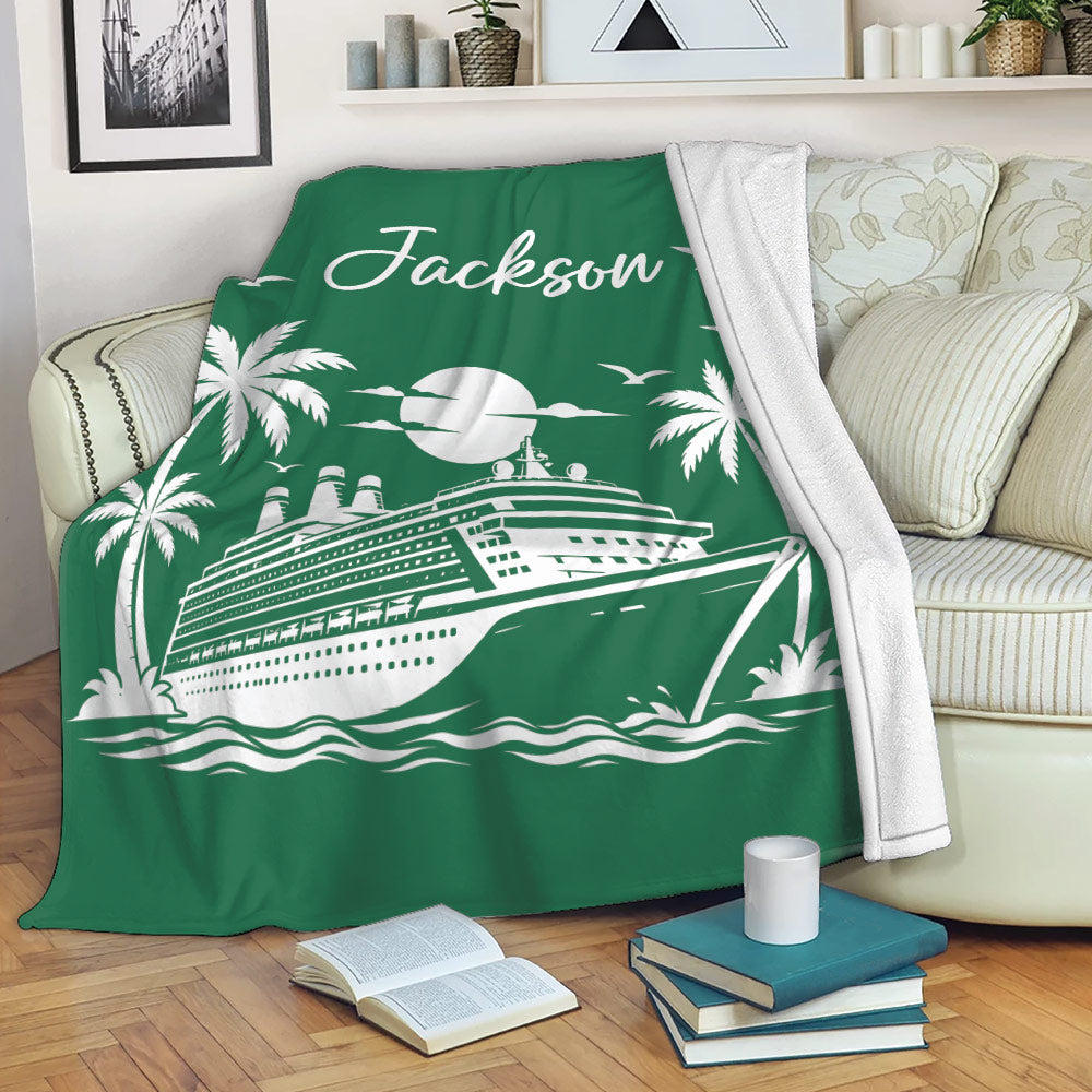 Green cruise ship blanket draped over a sofa with tropical island artwork and a cozy reading setting
