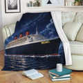 Cruise ship blanket styled on a living room sofa with dramatic ocean and night sky artwork
