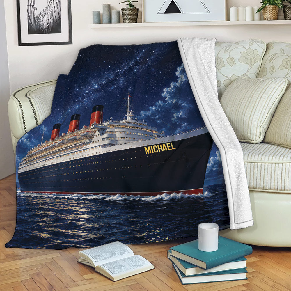 Cruise ship blanket styled on a living room sofa with dramatic ocean and night sky artwork