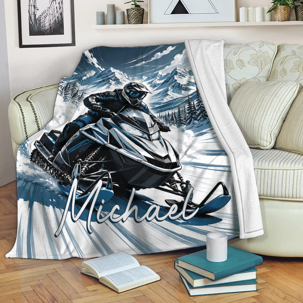 Snowmobile blanket draped over a living room sofa with blue and white mountain riding artwork