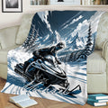 Snowmobile rider throw blanket displayed on a sofa with dramatic alpine scenery and winter artwork