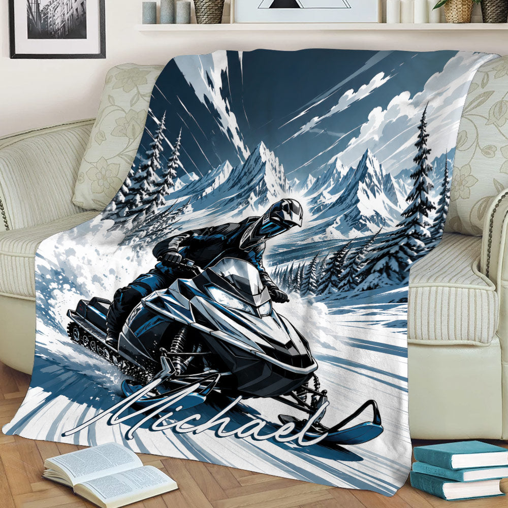 Snowmobile rider throw blanket displayed on a sofa with dramatic alpine scenery and winter artwork