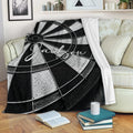 Black and white dart board blanket draped over a cozy living room sofa