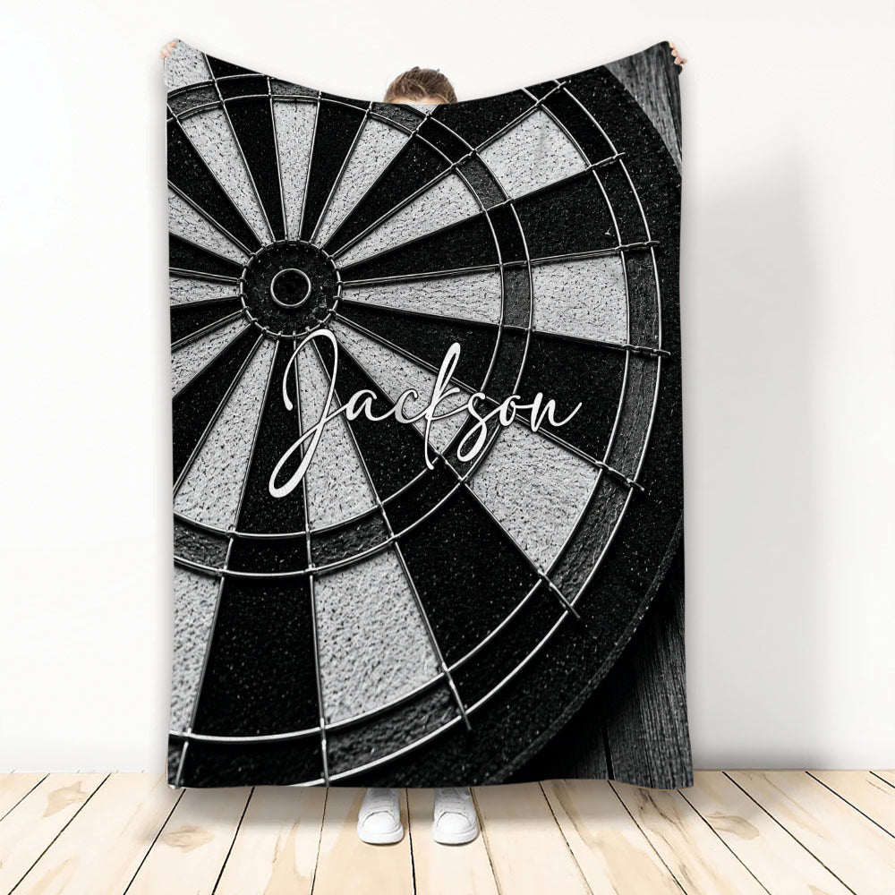 Black and white dart board throw blanket displayed in front of a person