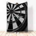 Black and white dart board throw blanket displayed in front of a person