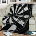 Close view of a black and white dart board blanket styled on a sofa
