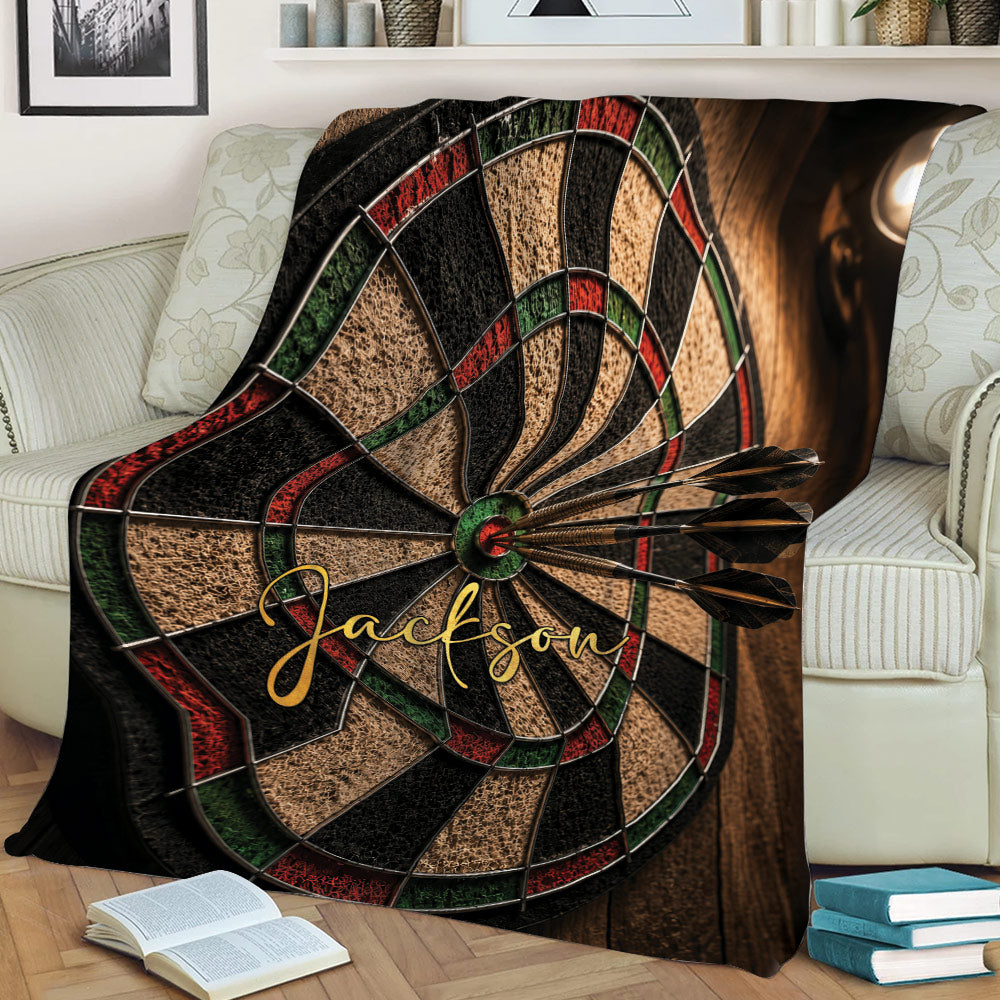 Dart board blanket styled across a sofa with darts and colorful game room artwork